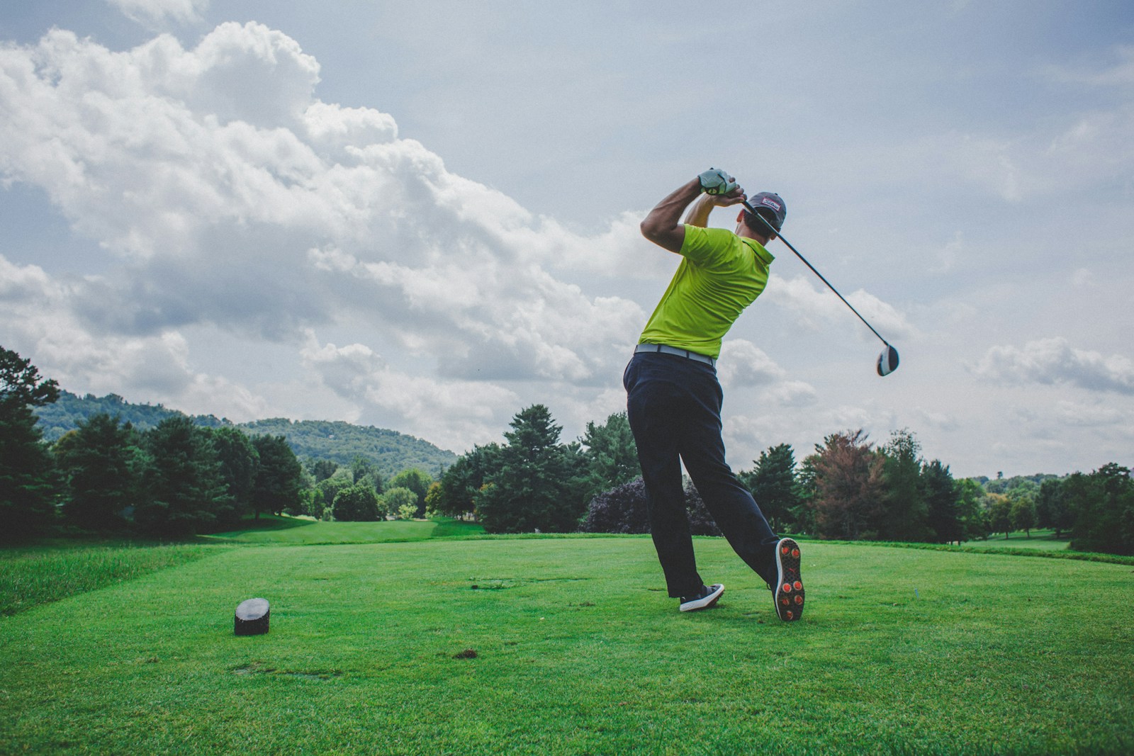 A golfer completing a swing on the course